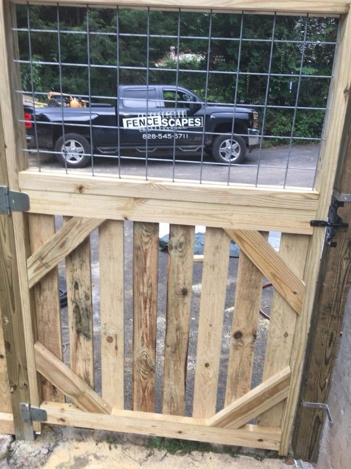 Close-up of a shop-built wood-frame gate with welded wire infill and a diagonal brace