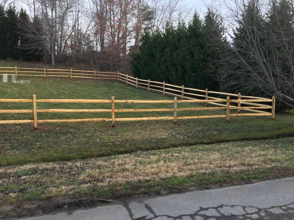 Split-rail fence with wire mesh